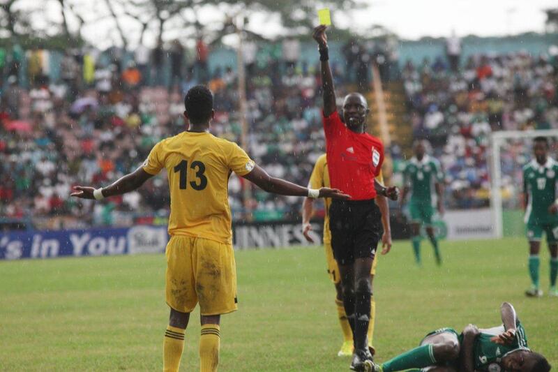 Gambian referee Bakary Papa Gassama issues a yellow to Ethiopia's Salahadin Bargicho on Saturday. Sunday Alamba / AP