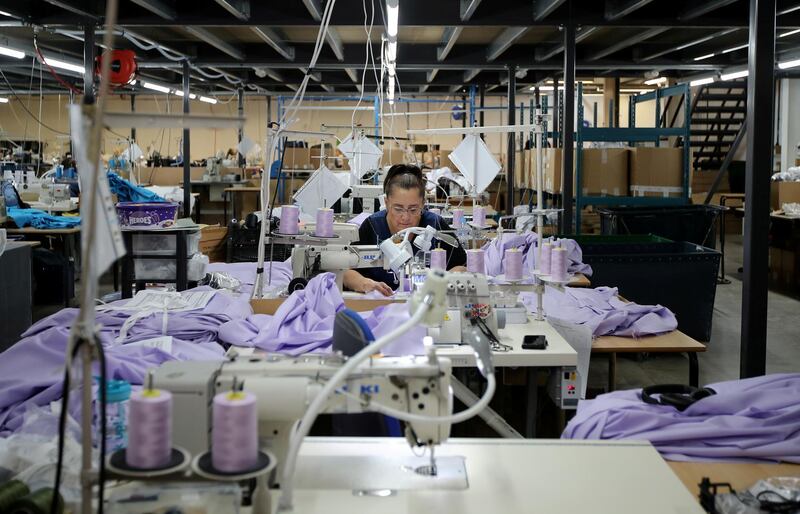 FILE PHOTO: Tibard employees make NHS uniforms at their factory in Dukinfield as the spread of the coronavirus disease (COVID-19) continues, Dukinfield, Britain, April 6, 2020. REUTERS/Molly Darlington/File Photo  GLOBAL BUSINESS WEEK AHEAD