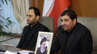 Iran's First Vice President Mohammad Mokhber, right, leads a cabinet meeting in Tehran on Monday with a photo of late President Ebrahim Raisi placed in front of the seat next to him. AFP