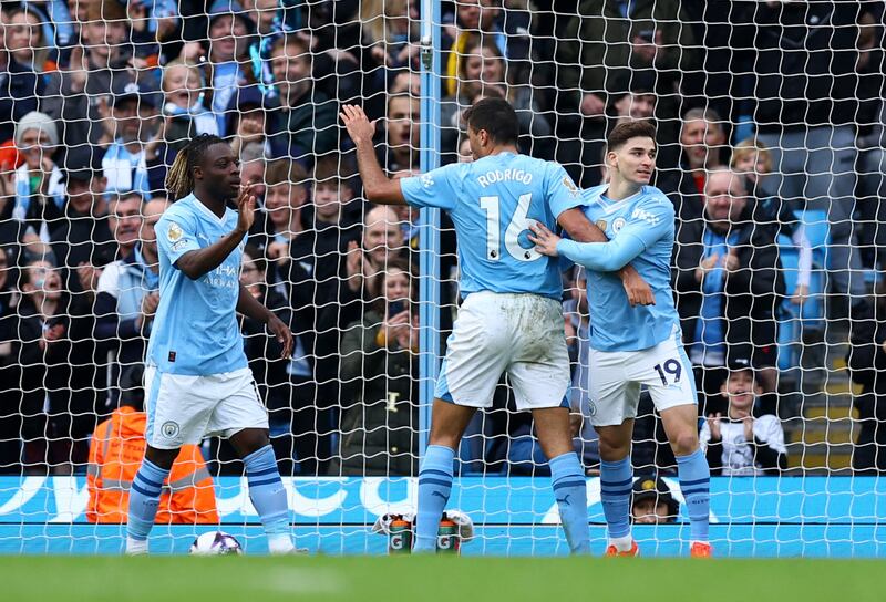 Manchester City's Julian Alvarez celebrates scoring their fifth goal with Jeremy Doku and Rodri. Reuters