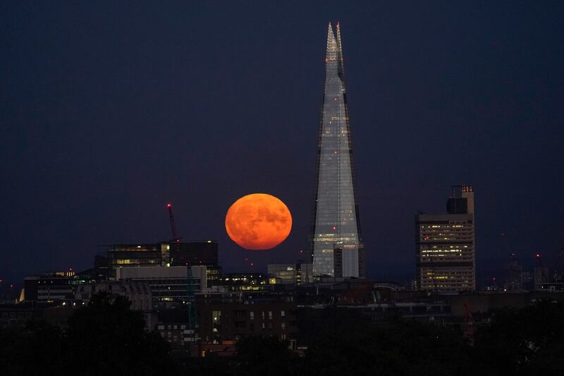 The supermoon rises behind The Shard in London. AP Photo