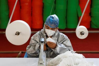 A man wears a protective face mask as he works at a mask factory, during the coronavirus outbreak in Kabul, Afghanistan July 2, 2020. REUTERS