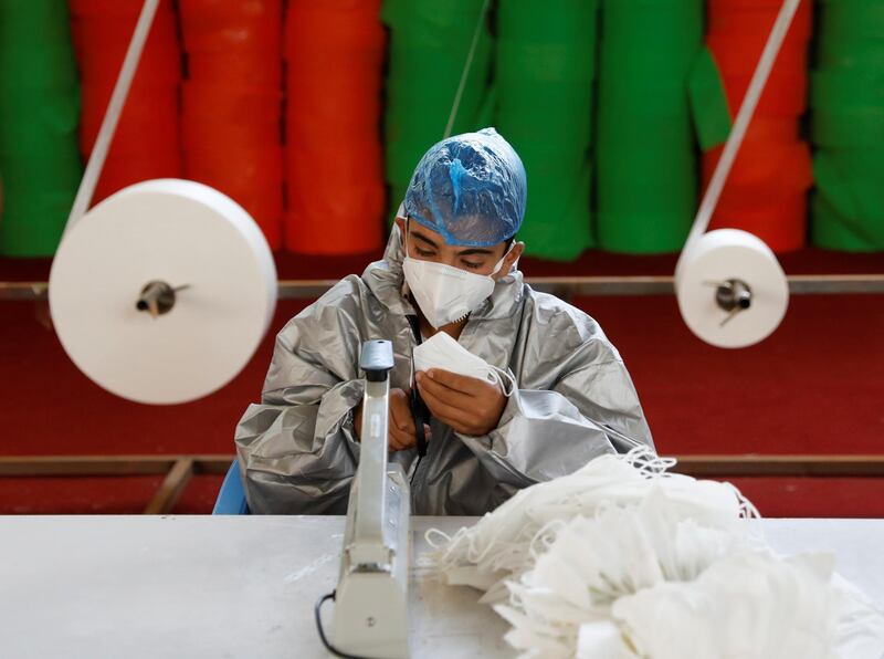 A man wears a protective face mask as he works at a mask factory, during the coronavirus disease (COVID-19) outbreak in Kabul, Afghanistan July 2, 2020. REUTERS/Mohammad Ismail