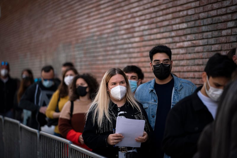 People line up outside a club to be screened for Covid-19 ahead of a music concert in Barcelona, Spain, on March 27, 2021. AP Photo