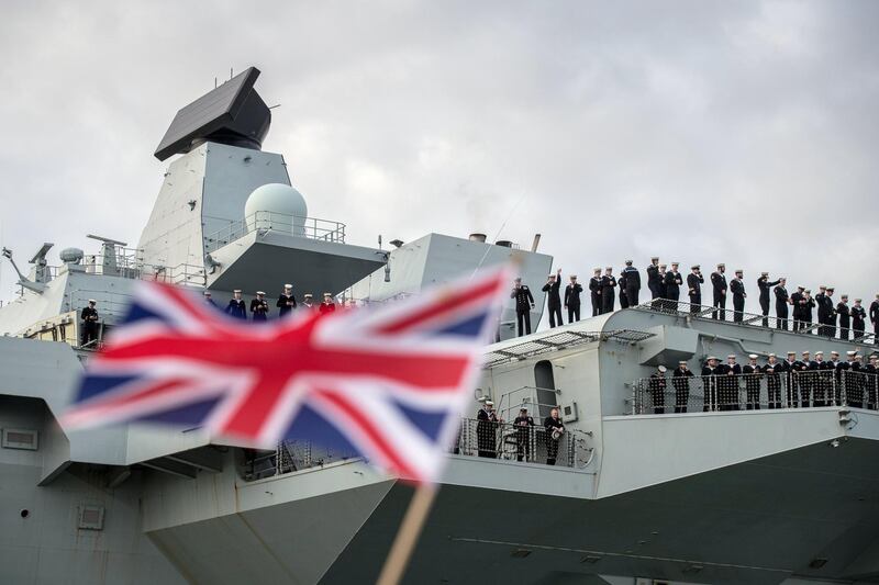 PORTSMOUTH, ENGLAND - DECEMBER 10:  People wave and cheer as HMS Queen Elizabeth returns to Portsmouth after 114 days away at sea, on December 10, 2018 in Portsmouth, England.  The navy's new three billion pound carrier set sail from the city in August and has been based off the coast of Virginia and Maryland during which F35 jets landed on her deck for the first time and also visited New York. (Photo by Matt Cardy/Getty Images)