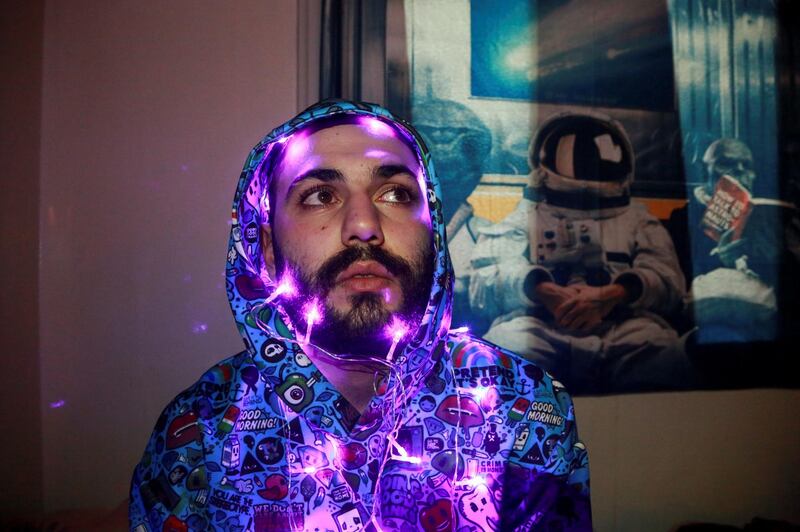 Ali, 25, an IT student, seen here with LEDs wrapped around his head, lives in Damascus. Ali says he could talk for days about the things that affected him during the war.  Reuters