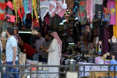 People wear protective face masks to prevent the spread of coronavirus at a shop in downtown Amman, Jordan. Reuters
