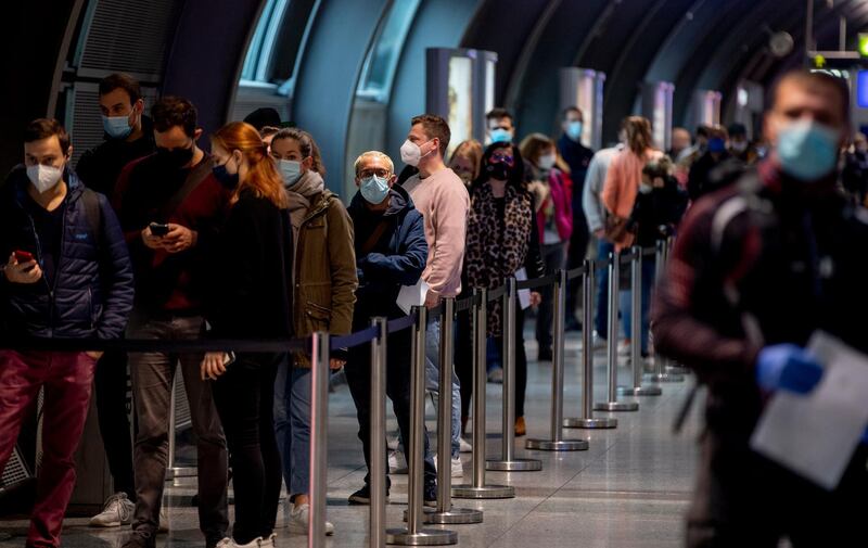 People queue at a Covid-19 test center at the airport in Frankfurt, Germany. AP Photo