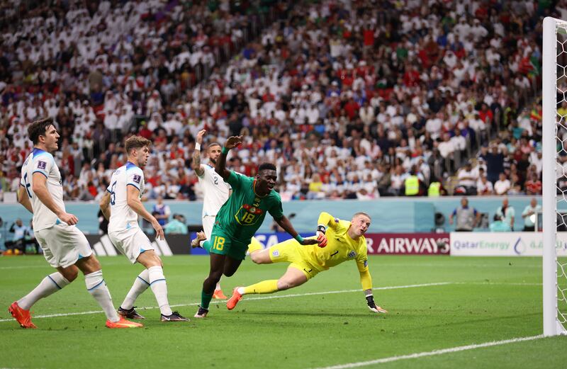 Ismaila Sarr of Senegal shoots just over the bar as Jordan Pickford of England dives. Getty 