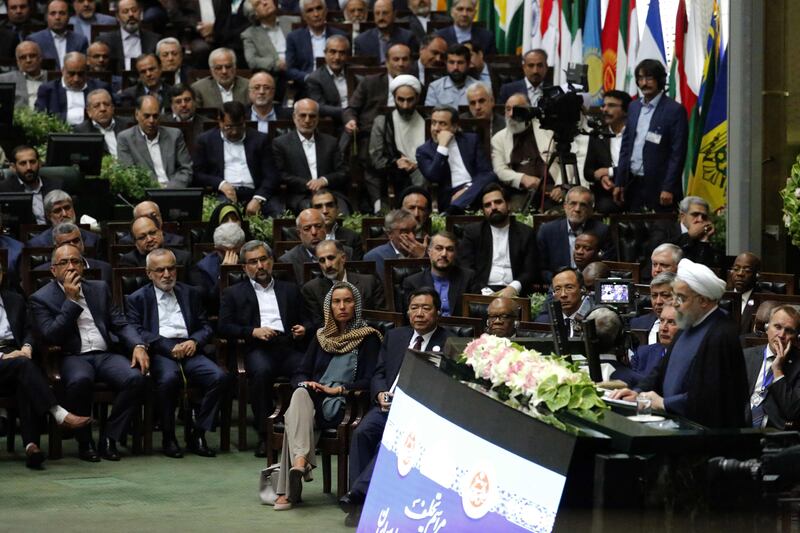 EU foreign policy chief Federica Mogherini, centre, listens as Iran's president Hassan Rouhani delivers a speech after being sworn in before parliament in Tehran, on August 5, 2017. AFP