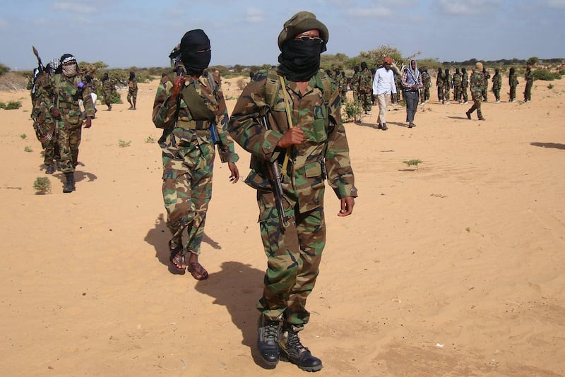 Somali Al-Shebab fighters gather on February 13, 2012 in Elasha Biyaha, in the Afgoei Corridor, after a demonstration to support the merger of Al-shebab and the Al-Qaeda network. Shebab insurgents staged rallies across Somalia on February 13  to celebrate their group's recognition by Osama bin Laden's successor as a member of the Islamist Al-Qaeda network. Al-Qaeda chief Ayman al-Zawahiri announced in a video message posted on jihadist forums on February 9, 2012 that Shebab fighters had joined ranks with the Islamist network.    AFP PHOTO / Mohamed Abdiwahab (Photo by Mohamed Abdiwahab / AFP)