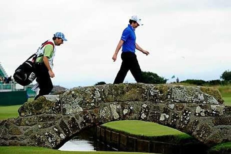 Rory McIlroy walks across the bridge on the 18th hole on his way to a round of 63 at St Andrews.