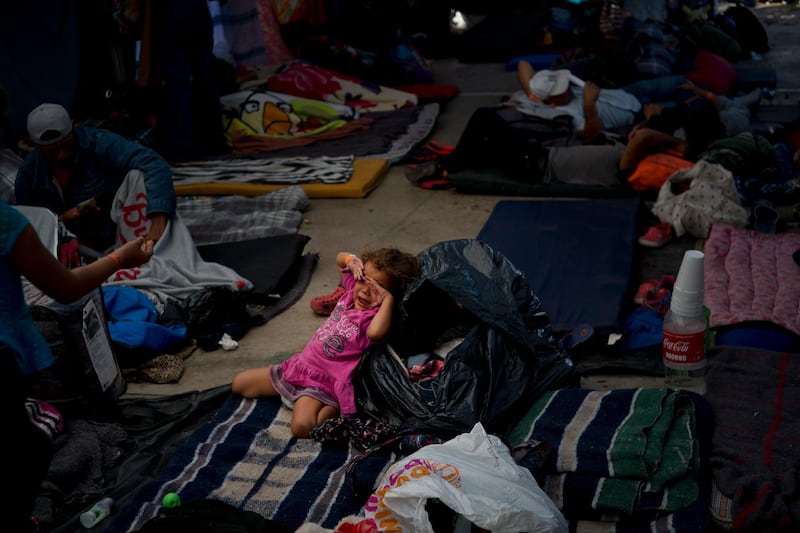 A migrant girl cries at a shelter in Tijuana, Mexico. AP