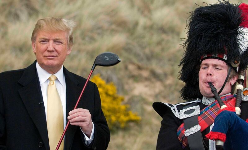 U.S. tycoon Donald Trump (L) poses for photographers during a visit to the construction site of his golf course on the Menie Estate near Aberdeen, Scotland on May 27, 2010.    Trump insisted his project to build a luxury golf course in Scotland will go ahead, despite a bid to block it by opponents buying land at the heart of the site.  Trump said he was determined to create the "greatest golf course in the world" after flying into Scotland on Wednesday to view progress on the site on the Aberdeenshire coast.   AFP PHOTO/Derek Blair (Photo by DEREK BLAIR / AFP)