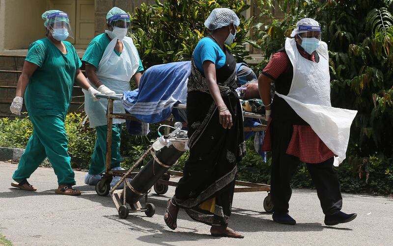 Health workers bring a suspected Covid-19 patient at KC General Hospital in Bangalore, India. EPA