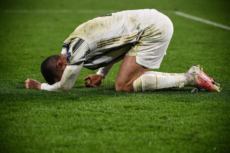 Cristiano Ronaldo reacts in pain after being tackled against Porto. AFP