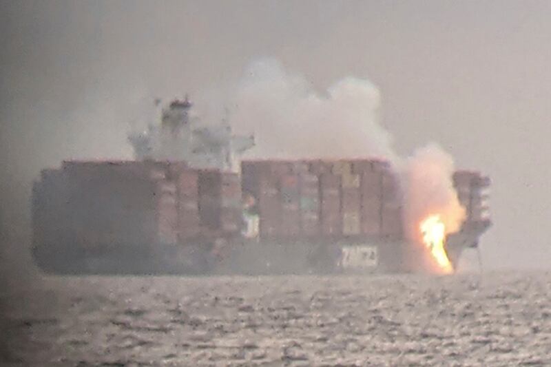 Fire cascades from the deck of the container ship 'Zim Kingston' into the sea off Victoria, Canada. Reuters