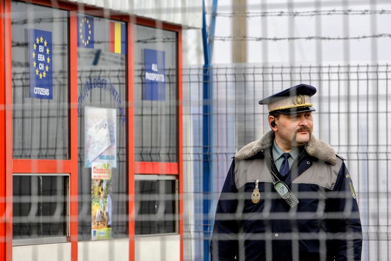 A border guard polices Romanian territory at a railway crossing point with Moldova. AP