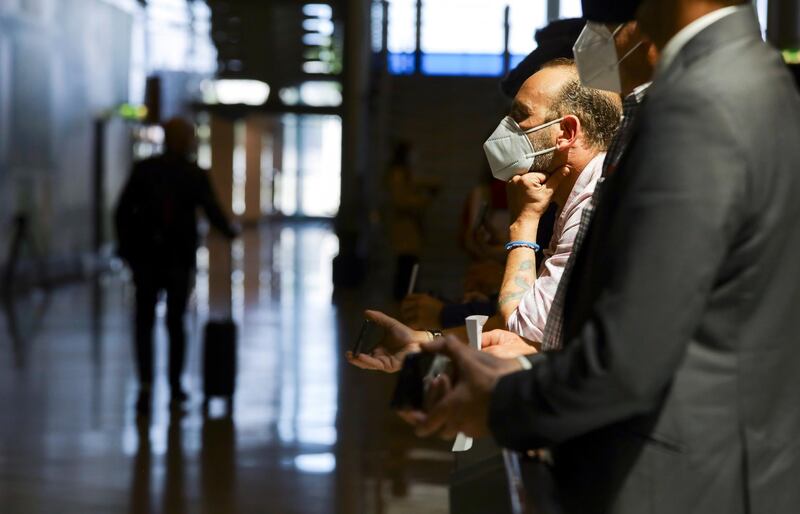 Travel agents wait for their clients at the arrivals terminal at Porto Airport in Portugal. Reuters