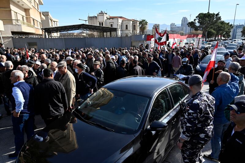 Retired Lebanese security force members block an entrance of the government palace to prevent ministers from attending a cabinet meeting. EPA