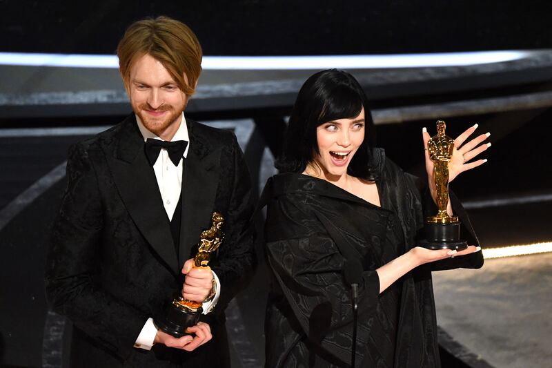 US singer-songwriter Finneas O'Connell, left, and US singer-songwriter Billie Eilish accept the award for Best Music (Original Song) for 'No Time to Die' onstage during the 94th Oscars at the Dolby Theatre in Hollywood, California. AFP