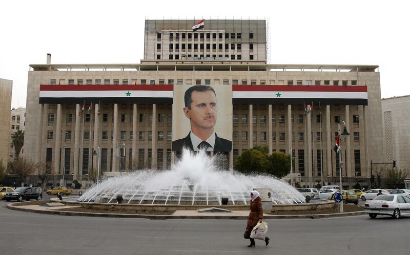 Syria’s central bank building decorated with a huge banner of President Bashar Al Assad in the capital, Damascus. AFP