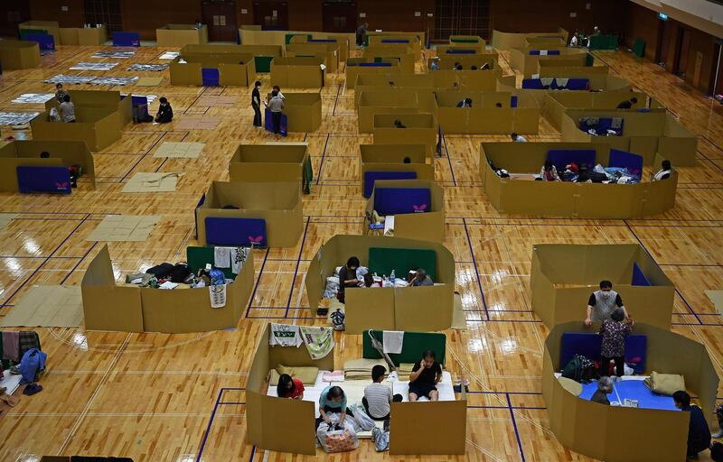 People displaced by floods in Japan's Kumamoto prefecture rest in socially distanced shelters at the Yatsushiro city general gymnasium.  AFP