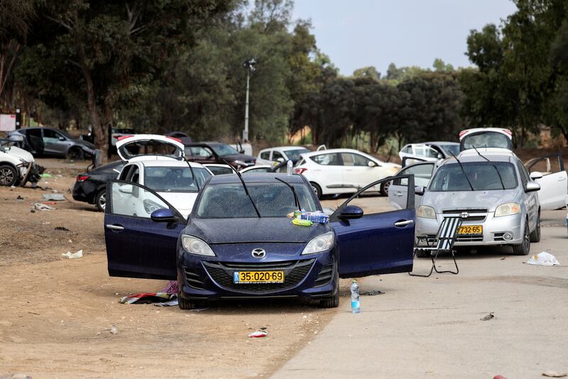 Cars are abandoned near where a festival was held before an attack by Hamas gunmen from Gaza that left at least 260 people dead. Reuters