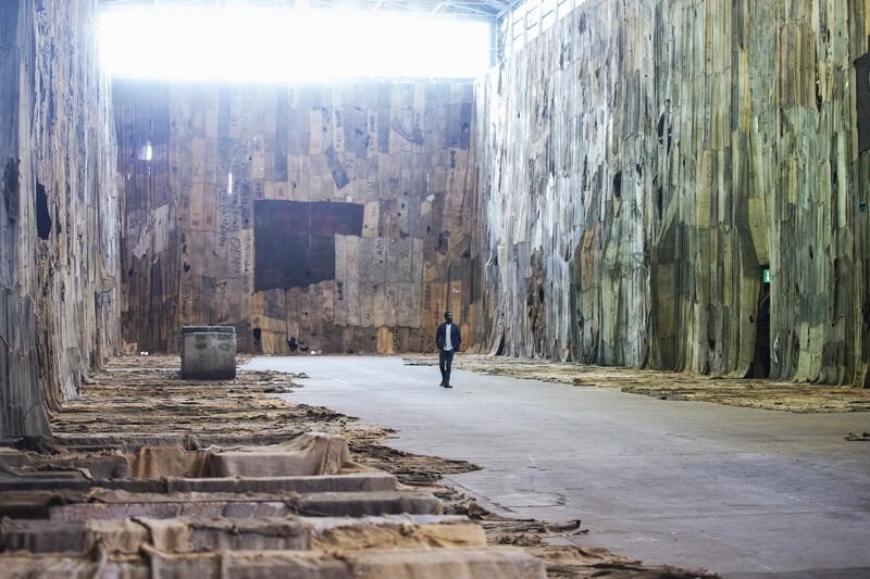 Ghanaian-born artist Ibrahim Mahama is seen with his large scale installation in the Turbine Hall on Cockatoo Island during the 22nd Biennale of Sydney.  Getty