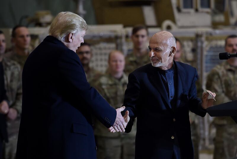 Afghan's President Ashraf Ghani shakes hands with US President Donald Trump. AFP