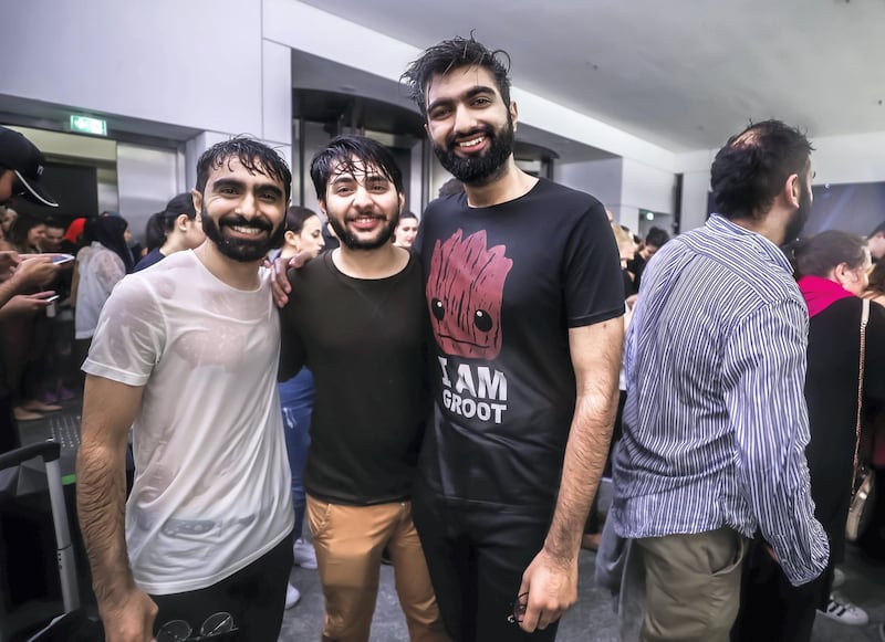 Abu Dhabi, U.A.E., November 12, 2018.  
Cancelled concert of Dua Lipa at the Louvre due to a sudden downpour and gusty winds.  Concert goers take refuge at the Louvre Museum area.  (L-R) Anas J., Aizaz A. and Waleed H.
Victor Besa / The National
Section:  NA
Reporter: