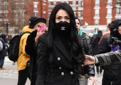 PARIS, FRANCE - FEBRUARY 28: A guest is seen wearing a Chanel mask outside the Balmain show during Paris Fashion Week: AW20 on February 28, 2020 in Paris, France. (Photo by Daniel Zuchnik/Getty Images)