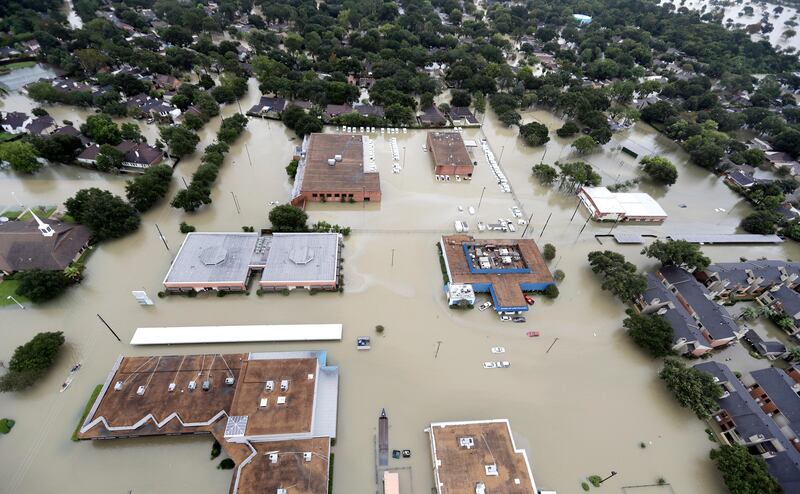 Water from Addicks Reservoir flows into neighborhoods as floodwaters from Tropical Storm Harvey rise Tuesday, Aug. 29, 2017, in Houston. (AP Photo/David J. Phillip)