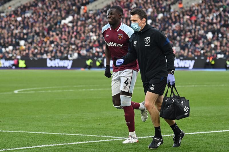 West Ham United's French defender Kurt Zouma receives medical attention during the English Premier League match against Chelsea at The London Stadium on December 4, 2021. AFP