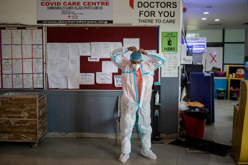 A paramedic prepares for duty at a makeshift Covid-19 care center at an indoor sports stadium in New Delhi. AP Photo