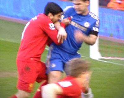 Rex Features Ltd. do not claim any Copyright or License of this image. 
Mandatory Credit: Photo by Shutterstock (2303441a)
Luis Suarez biting into the arm of Chelsea defender Branislav Ivanovic
Liverpool v Chelsea, FA Premier League Football Match, Anfield, Britain - 21 Apr 2013