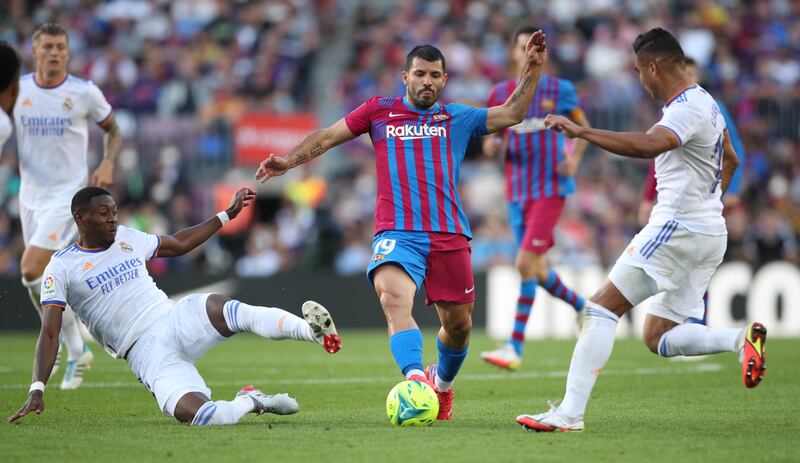 Barcelona striker Sergio Aguero challenges for the ball against Real Madrid's David Alaba and Casemiro. Reuters