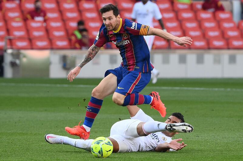 Barcelona's Lionel Messi skips over a challenge by Casemiro of Real. AFP