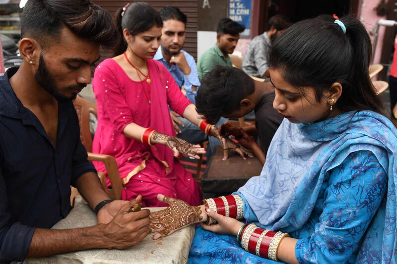 Hindu women prepare for the festival.  AFP
