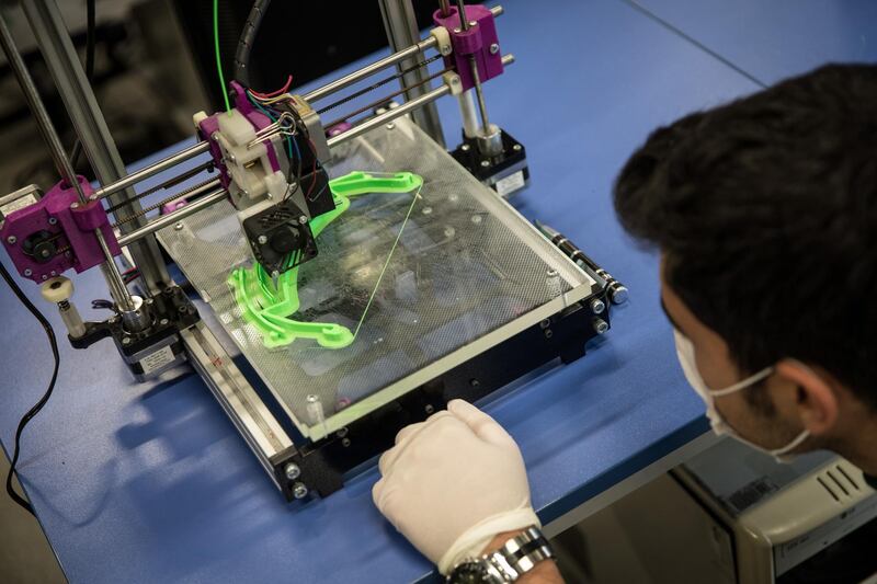 A teacher monitors a 3D printer making parts for face shields amid the Covid-19 outbreak at a Vocational and Technical Anatolian School in Istanbul, Turkey. Getty Images