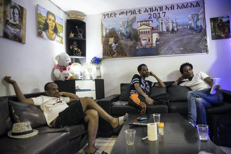 Scenes from home decorate the walls of the  tiny apartment where Eritrean asylum seekers Michael Abrahams (left) and Isake Malke(right )share a tiny rented apartment that costs over  $1000 per month for in south Tel Aviv. (Photo by Heidi Levine for The National).