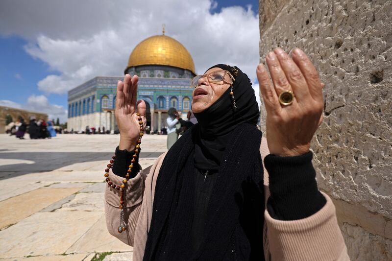 A woman offers first Friday noon prayers of Ramadan near the Dome of the Rock shrine, at the Al Aqsa Mosque compound, in the Old City of occupied East Jerusalem. AFP