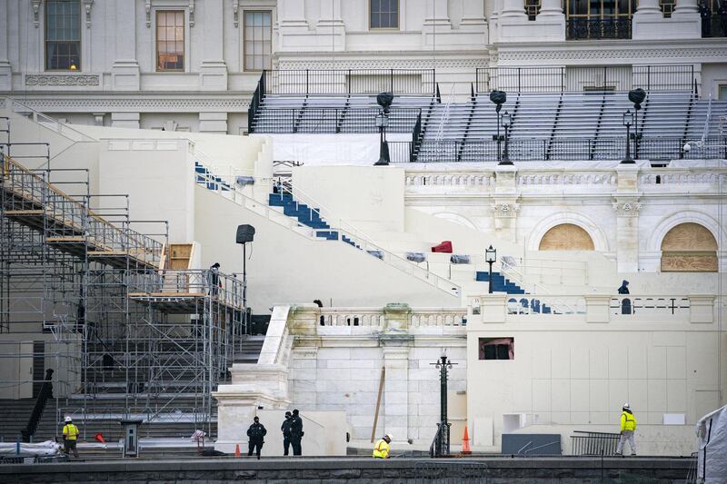 Workers stand near construction for the inauguration at the US Capitol in Washington, DC. Bloomberg