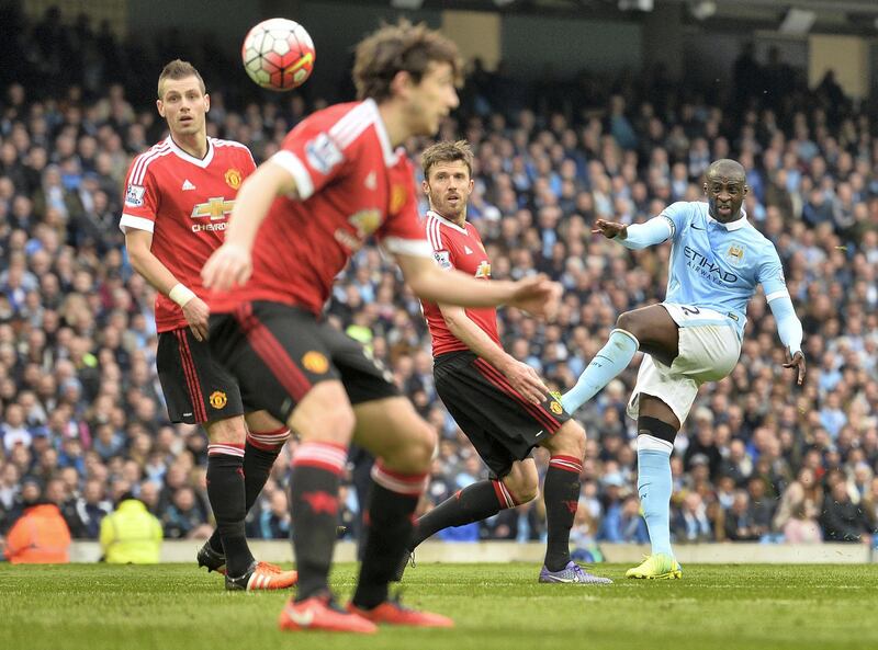 Manchester City's Ivorian midfielder and captain Yaya Toure (R) attempts a shot on goal during the English Premier League football match between Manchester City and Manchester United at the Etihad Stadium in Manchester, north west England, on March 20, 2016. (Photo by PAUL ELLIS / AFP) / RESTRICTED TO EDITORIAL USE. No use with unauthorized audio, video, data, fixture lists, club/league logos or 'live' services. Online in-match use limited to 75 images, no video emulation. No use in betting, games or single club/league/player publications. / 