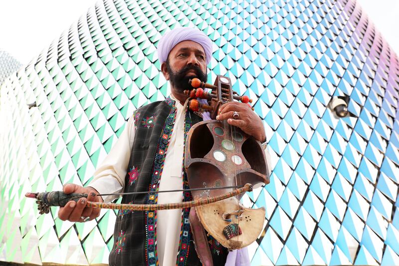 Sachu Khan with his musical instrument called ‘Saroz’ at the Pakistan pavilion. Pawan Singh / The National