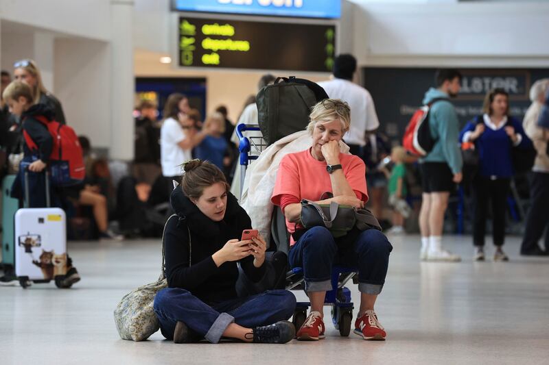 Passengers wait at Belfast International Airport, Ireland. AP