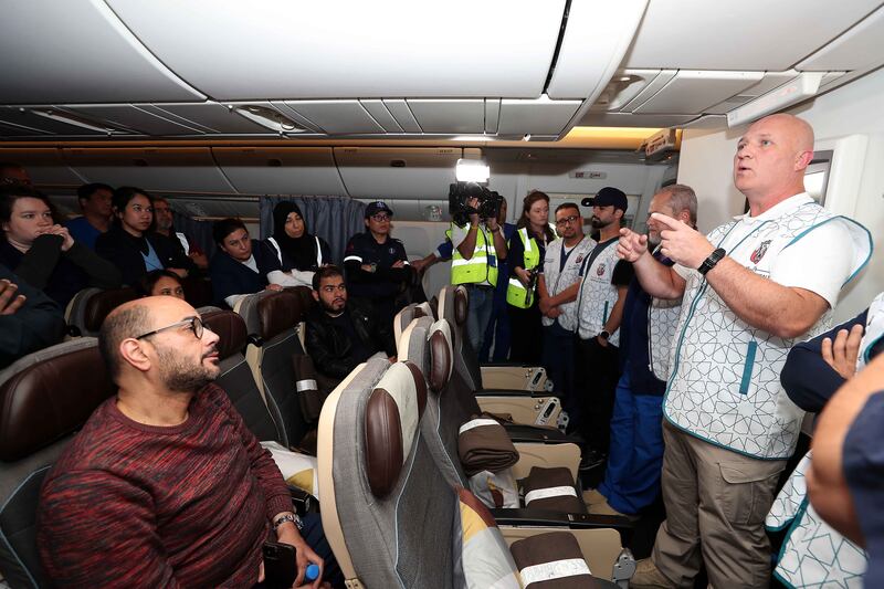Flight medical commander Joe Coughlan, right, briefs medical staff before landing at Al Arish airport in Egypt