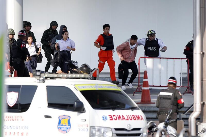 Soldiers evacuate hostages from mass shooting scene at the Terminal 21 shoppibng mall in Nakhon Ratchasima, Thailand.  EPA