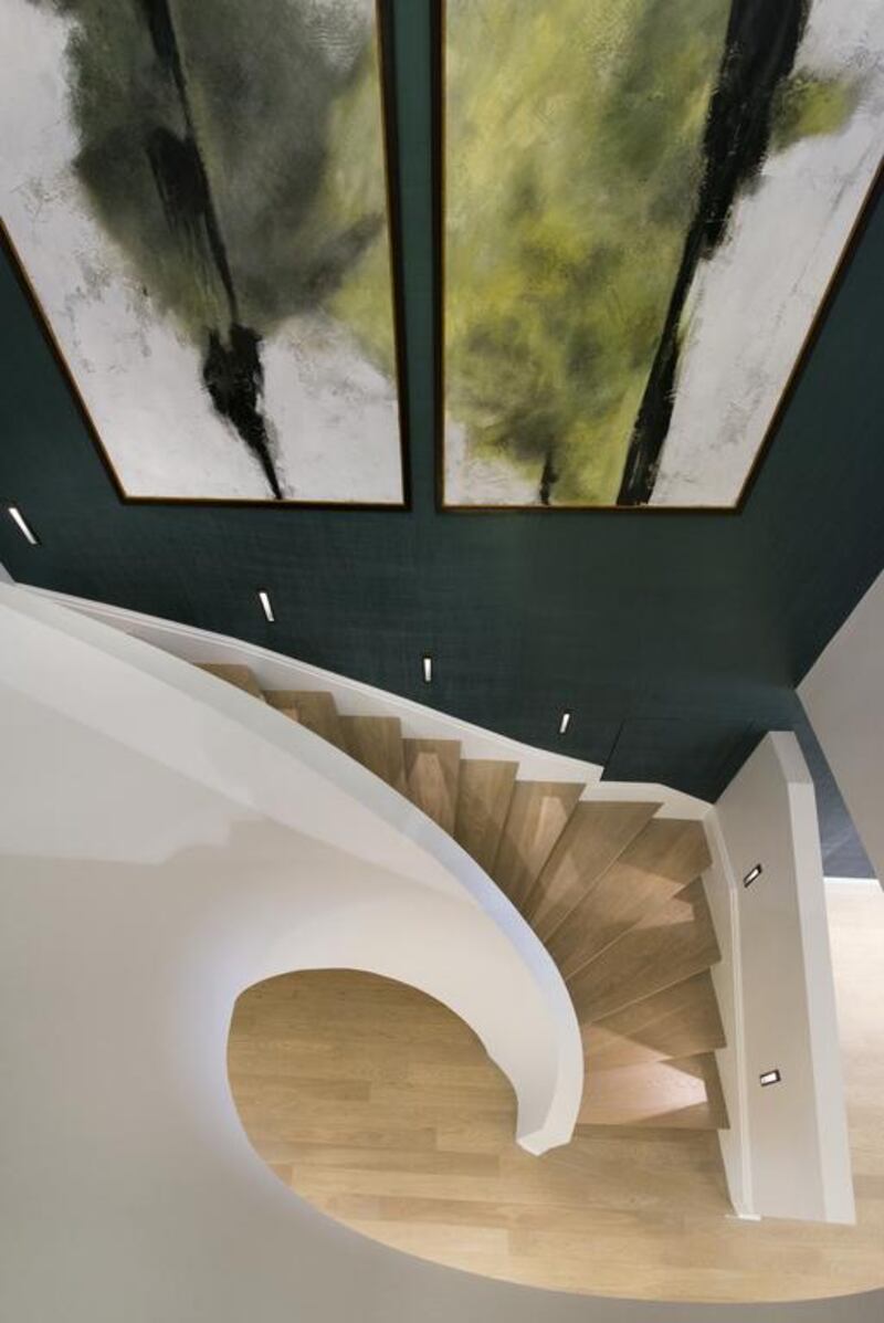 A curved staircase at one of the residences at The Park Crescent. Courtesy Amazon Property