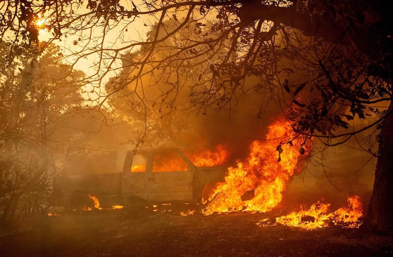 A truck burns at a residence as the Mendocino Complex fire pushes forward in Lakeport, California.  AFP PHOTO / JOSH EDELSON